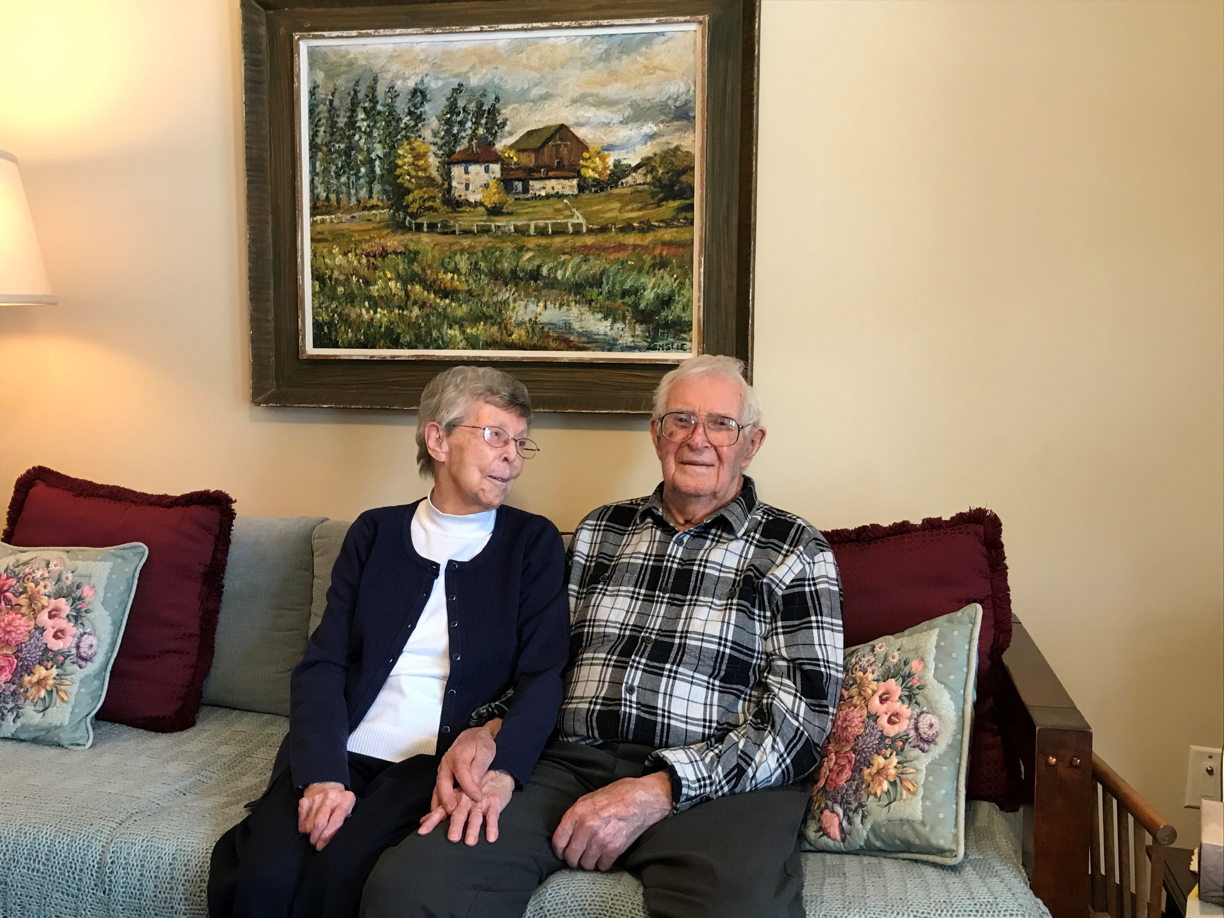Jean and warren sit together in their suite at Riverside Glen.