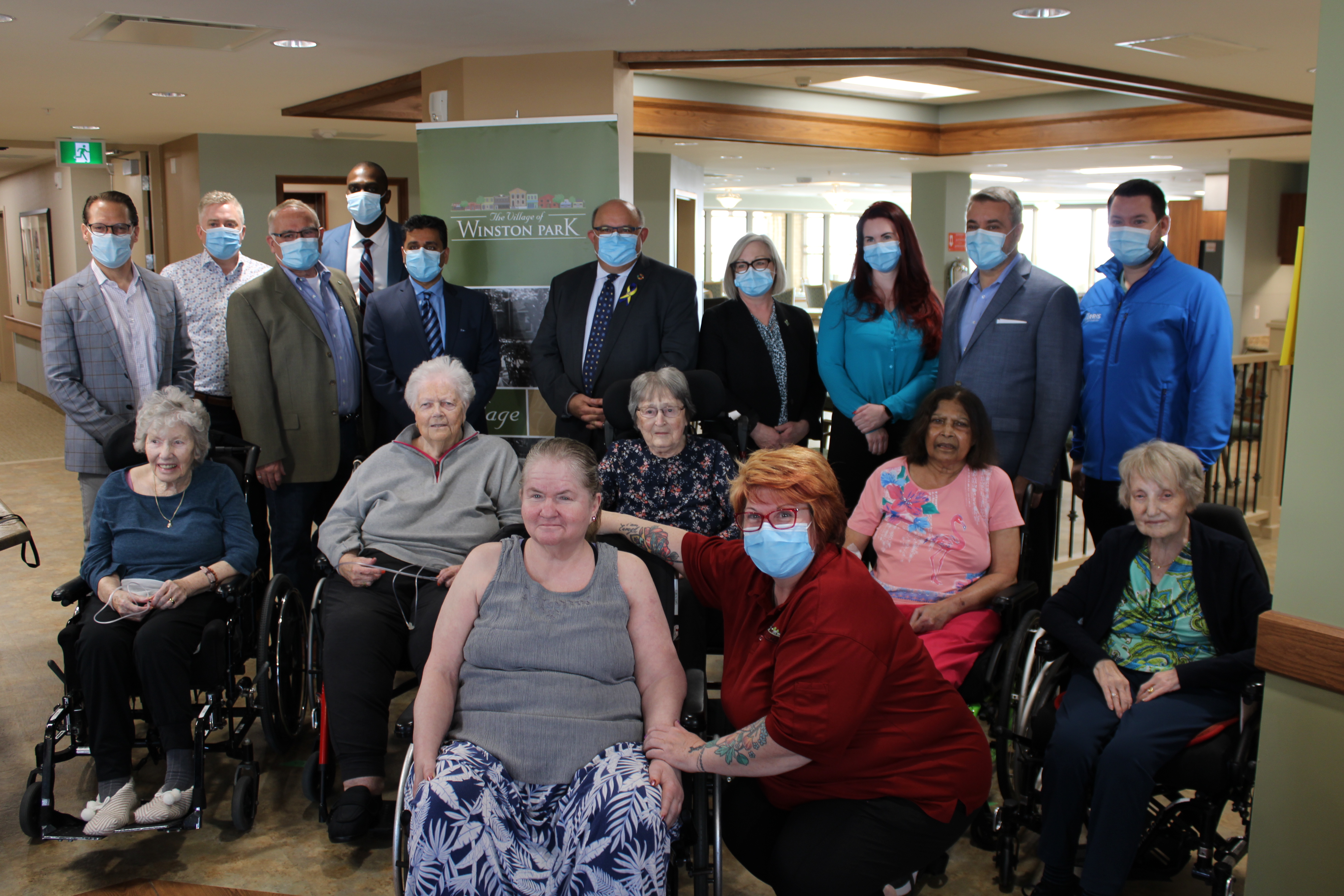 Residents of the new Winston park pose with dignitaries during a visit with Minister of Long Term Care, Paul Calandra