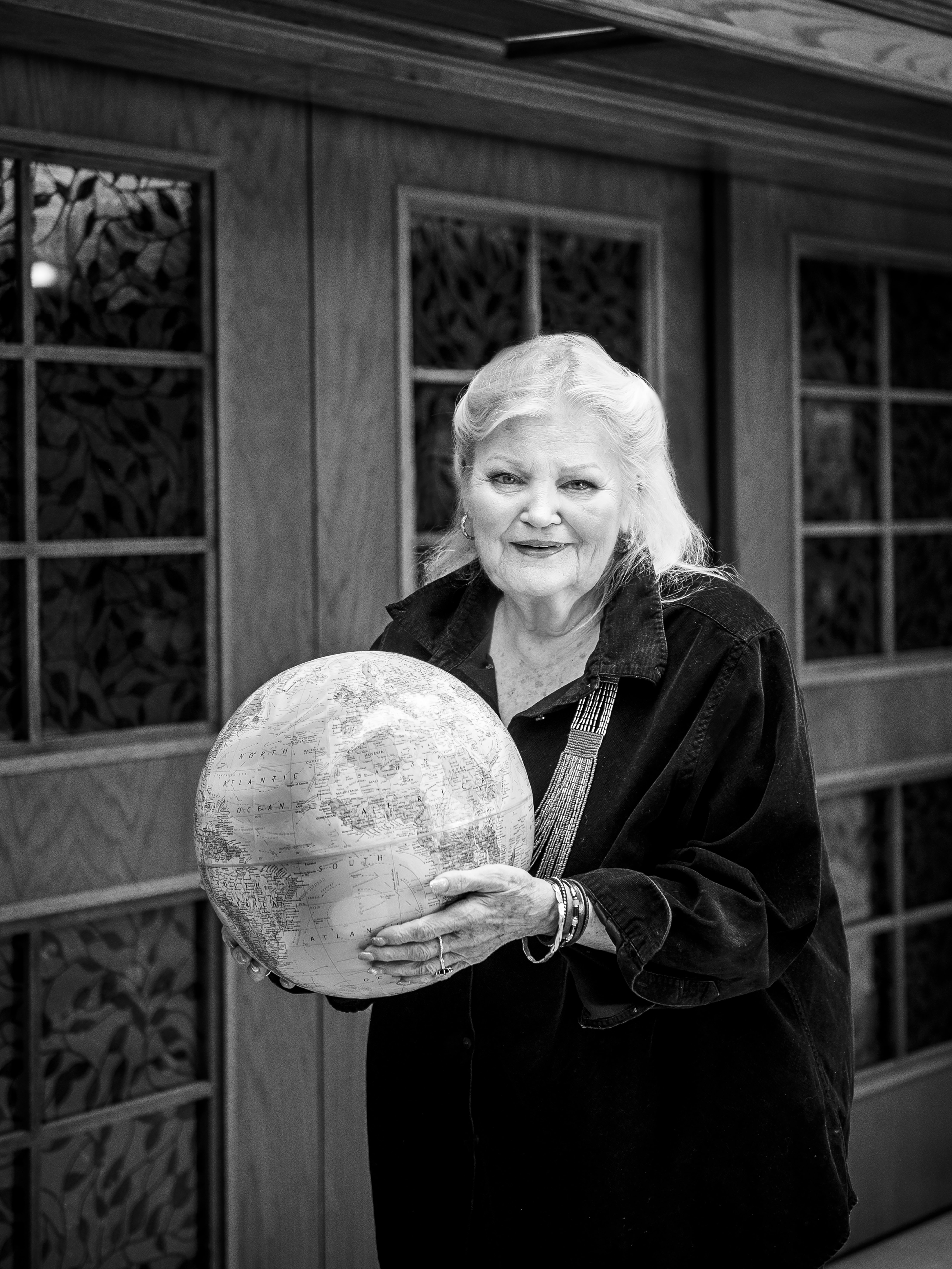 Jane Bagnall holding a globe to highlight her passion for supporting international students