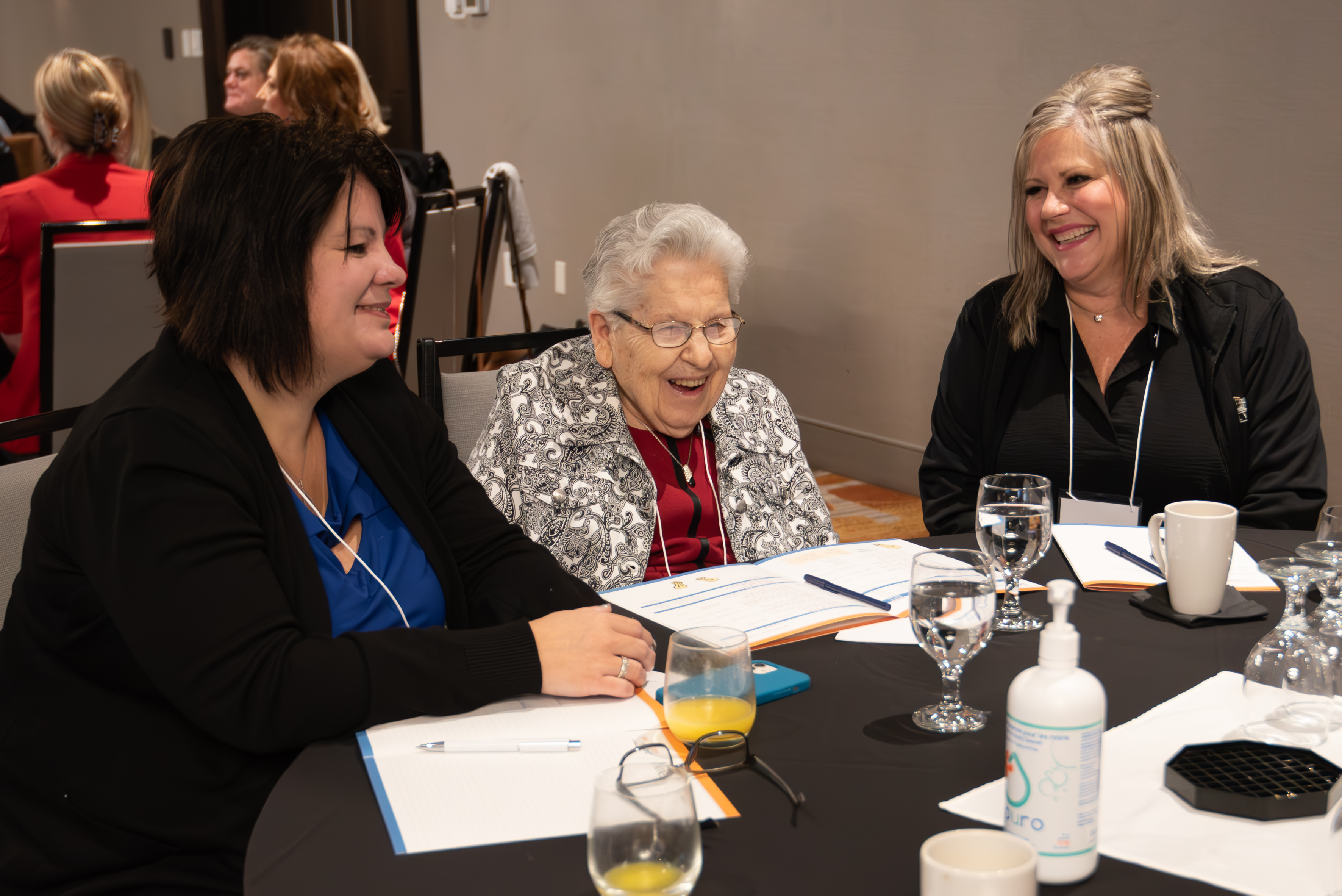 A Schlegel Villages residents is joined by two team members during the annual Innovation Summit.