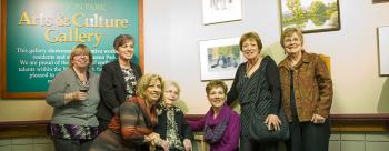 Margaret Dallaire sitting in between her six daughters in front of the Winston Park gallery
