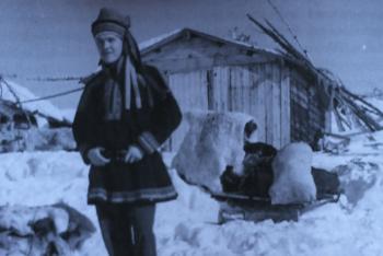 Black and white photo of Morris standing in the snow in traditional Norwegian garb
