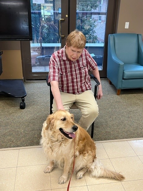 resident spending time with visiting Dog 