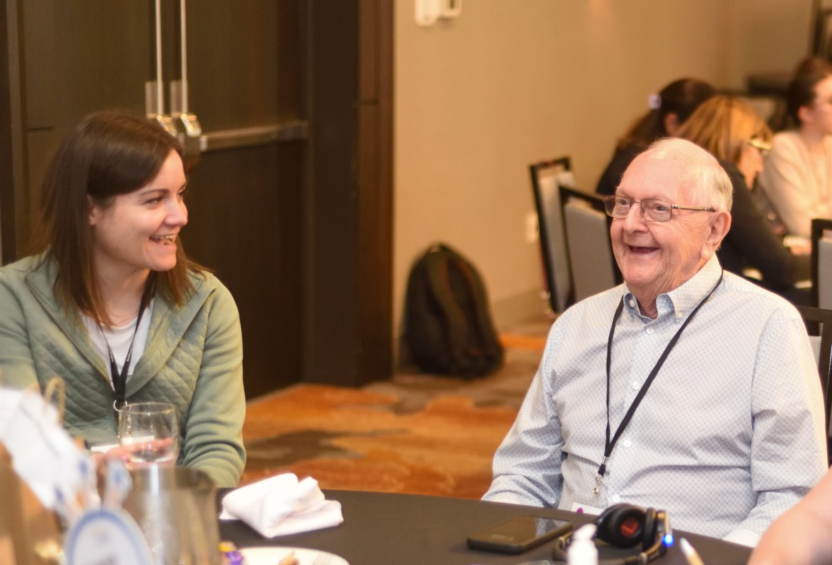 Alysha and a resident share laughter while participating in the 10th annual Innovation Summit.